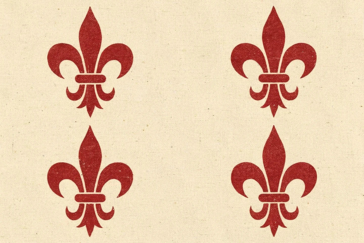 Illustration: four madder-red fleurs-de-lis in a block-print style, evenly spaced in two rows on a warm cream cotton-textured ground, each with three petals bound by a single band.